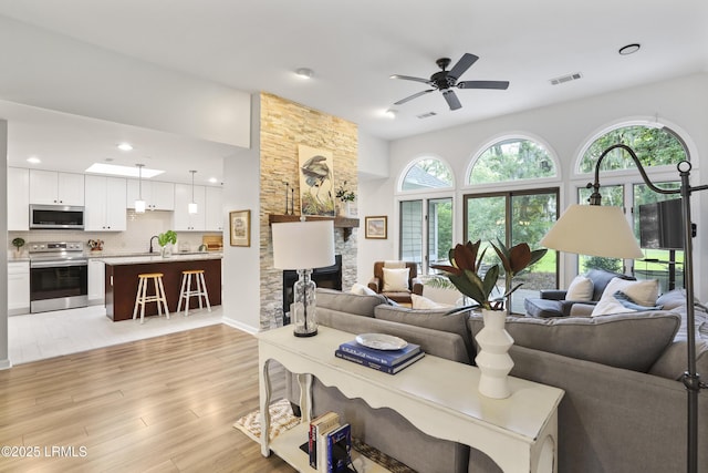 485 Bb Sams Dr, Saint Helena Island, SC 29920 - living area with ceiling fan, light wood-style floors, recessed lighting, and a stone fireplace