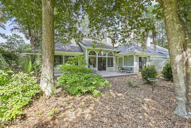 485 Bb Sams Dr, Saint Helena Island, SC 29920 - rear view of property with a chimney, a patio area, and a shingled roof