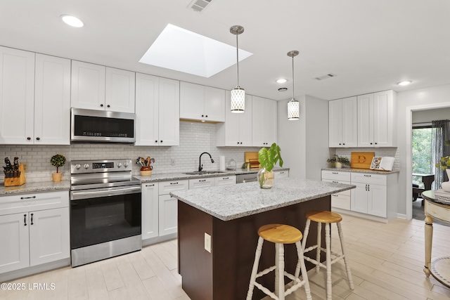 485 Bb Sams Dr, Saint Helena Island, SC 29920 - kitchen featuring stainless steel appliances, a skylight, decorative backsplash, and recessed lighting