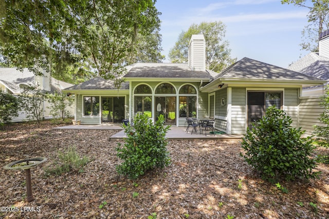 485 Bb Sams Dr, Saint Helena Island, SC 29920 - back of property with a chimney, a patio area, and roof with shingles