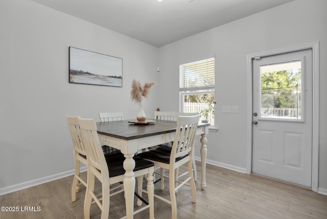 dining room with plenty of natural light and light hardwood / wood-style flooring