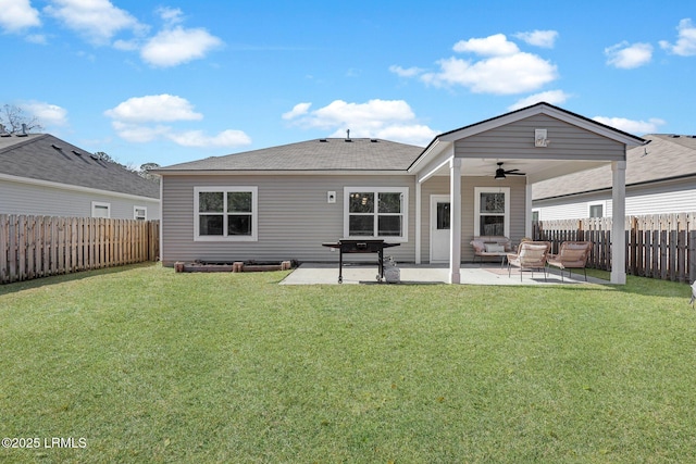 back of house featuring ceiling fan, a yard, and a patio area