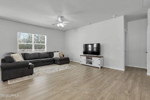 living room with ceiling fan and light wood-type flooring