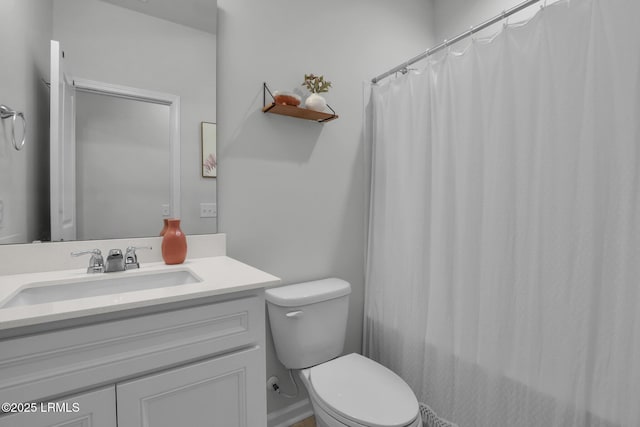 bathroom featuring vanity, curtained shower, and toilet