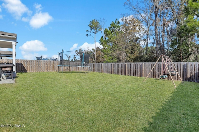 view of yard with a trampoline