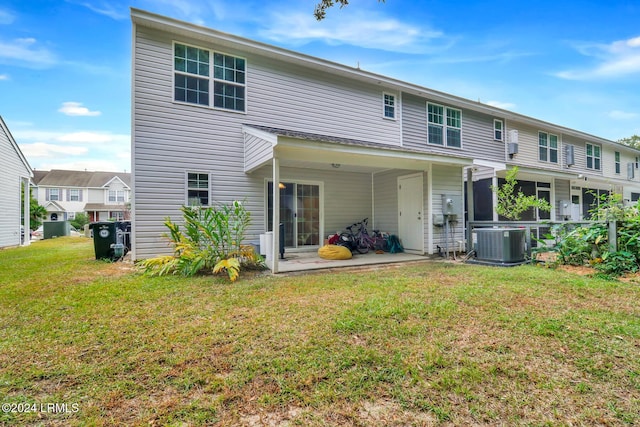 back of house featuring a patio, a yard, and central air condition unit