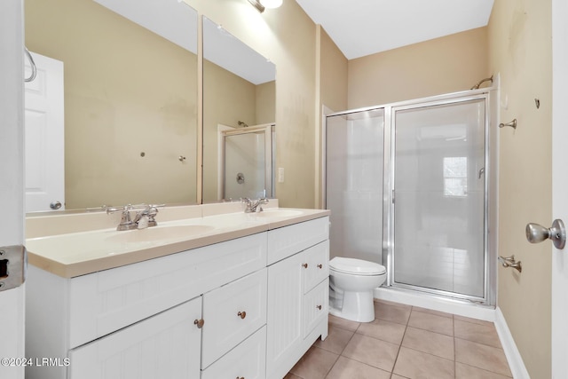 bathroom featuring vanity, toilet, a shower with shower door, and tile patterned flooring