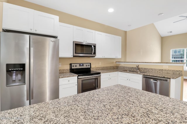 kitchen featuring white cabinetry, sink, light stone countertops, and appliances with stainless steel finishes