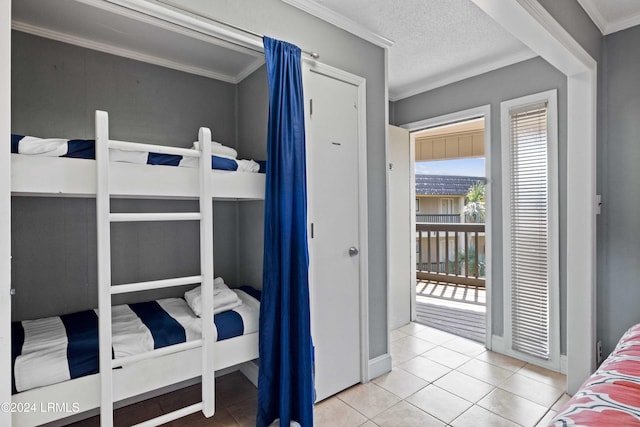 tiled bedroom featuring crown molding, access to exterior, and a textured ceiling