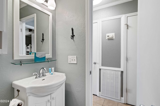 bathroom featuring ornamental molding, tile patterned floors, and vanity