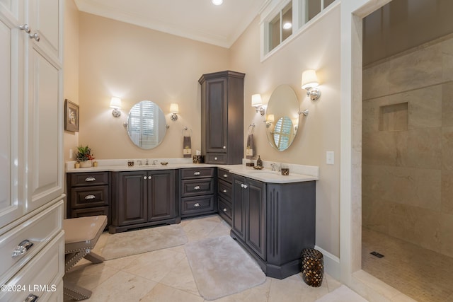 bathroom featuring crown molding, tiled shower, and vanity