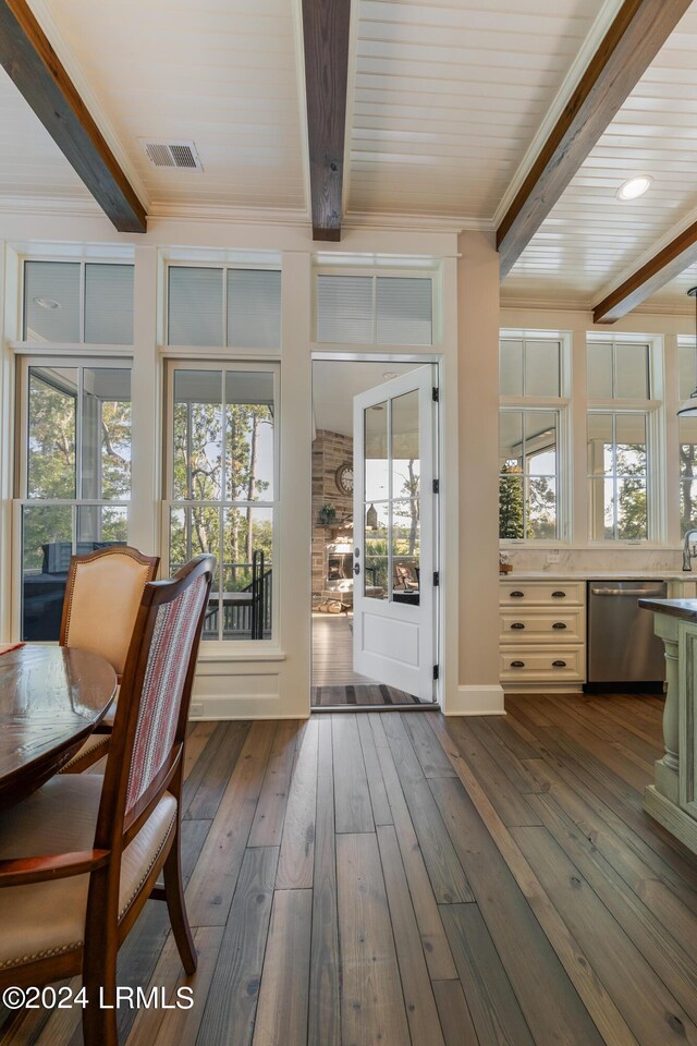 interior space with beam ceiling and a wealth of natural light