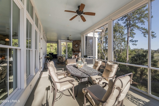 sunroom / solarium featuring ceiling fan