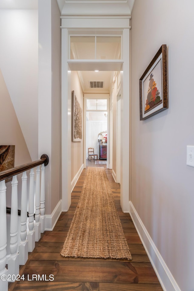 hallway featuring crown molding and dark wood-type flooring