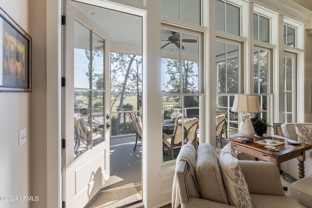 doorway to outside featuring ceiling fan