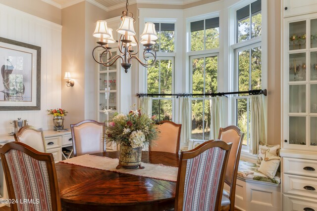 dining area featuring an inviting chandelier and crown molding