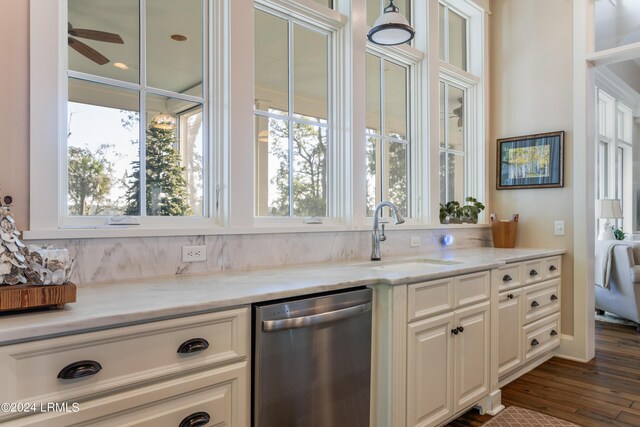 kitchen with white cabinetry, sink, stainless steel dishwasher, ceiling fan, and light stone countertops