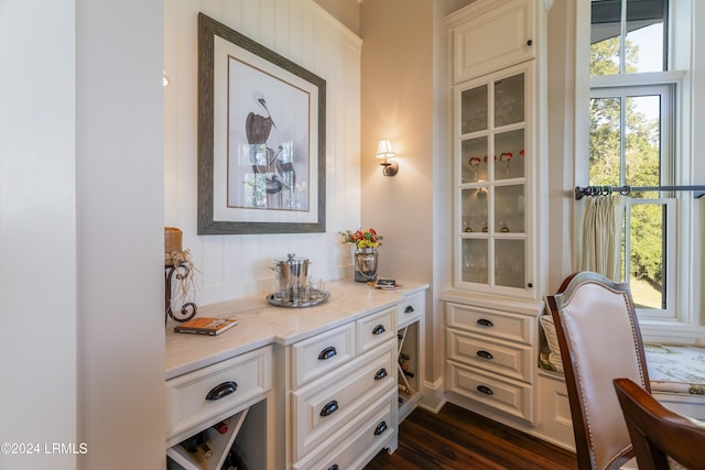 interior space featuring dark hardwood / wood-style flooring and white cabinetry