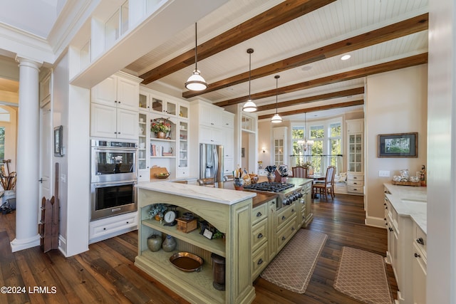 kitchen with ornate columns, a center island, green cabinets, stainless steel appliances, and white cabinets