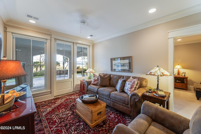 living room with ornamental molding, carpet floors, and a wealth of natural light