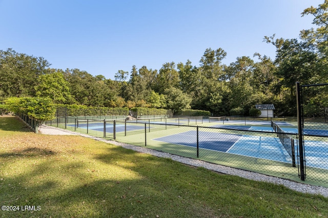 view of tennis court with a lawn