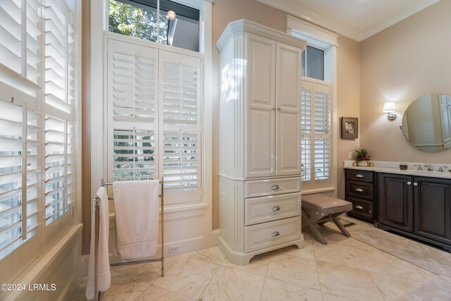 bathroom with crown molding and vanity