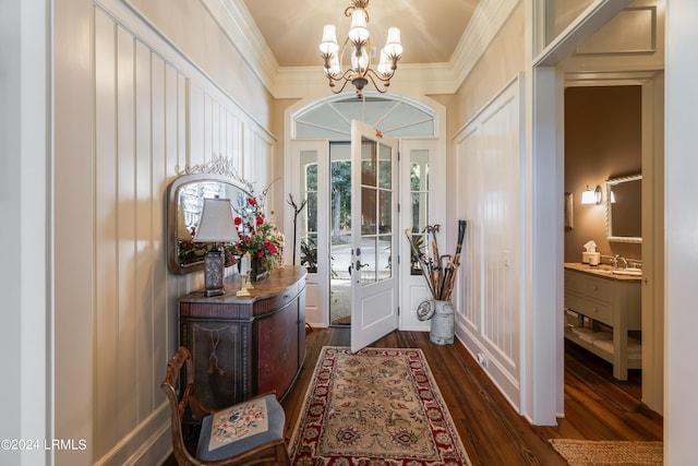 interior space featuring sink, crown molding, dark wood-type flooring, and a notable chandelier