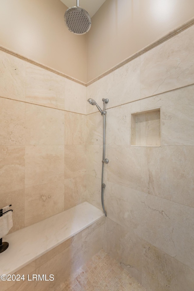 bathroom with tiled shower