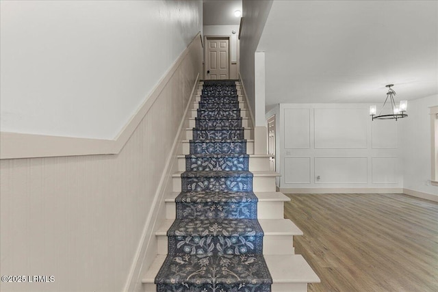 20 Pennyroyal Way, Beaufort, SC 29906 - stairway featuring a decorative wall, a chandelier, and wood finished floors
