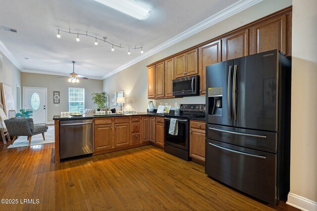 47 River Tree Cir, Bluffton, SC 29910 - kitchen with a peninsula, dark wood-style floors, dark countertops, visible vents, and stainless steel appliances