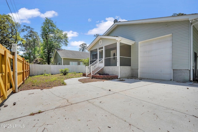47 River Tree Cir, Bluffton, SC 29910 - exterior space with an attached garage, a sunroom, concrete driveway, and fence