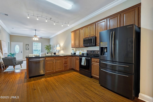 47 River Tree Cir, Bluffton, SC 29910 - kitchen featuring dark wood-style flooring, dark countertops, a peninsula, appliances with stainless steel finishes, and visible vents