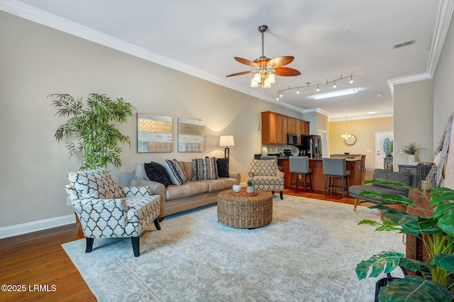 47 River Tree Cir, Bluffton, SC 29910 - living area featuring dark wood finished floors, baseboards, visible vents, a ceiling fan, and ornamental molding