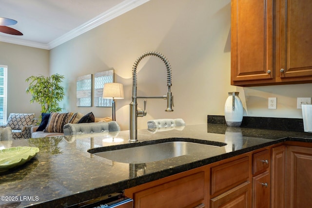 47 River Tree Cir, Bluffton, SC 29910 - kitchen featuring brown cabinetry, ornamental molding, dark stone countertops, and a sink