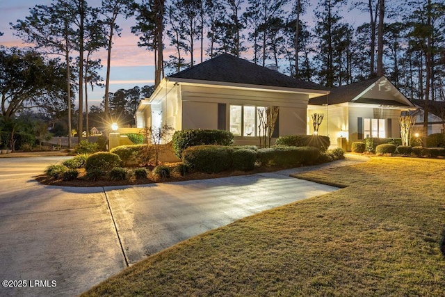 property exterior at dusk with a yard