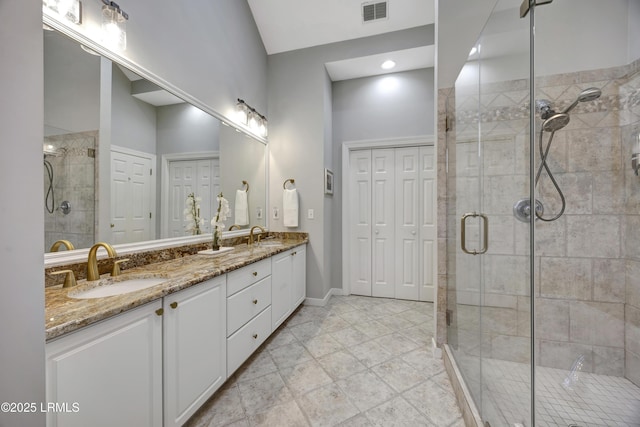 bathroom with vanity and a shower with shower door