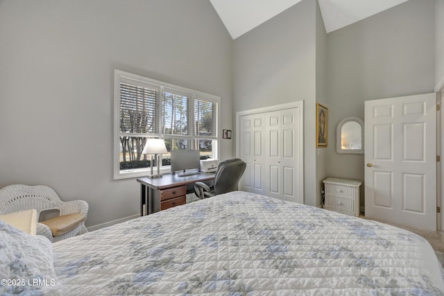 bedroom with carpet flooring, high vaulted ceiling, and a closet