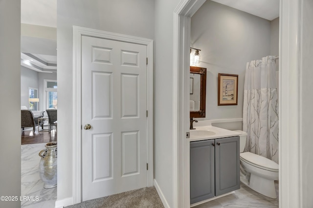 bathroom with vanity, curtained shower, and toilet