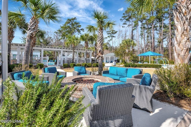 view of patio featuring a pergola and an outdoor living space with a fire pit