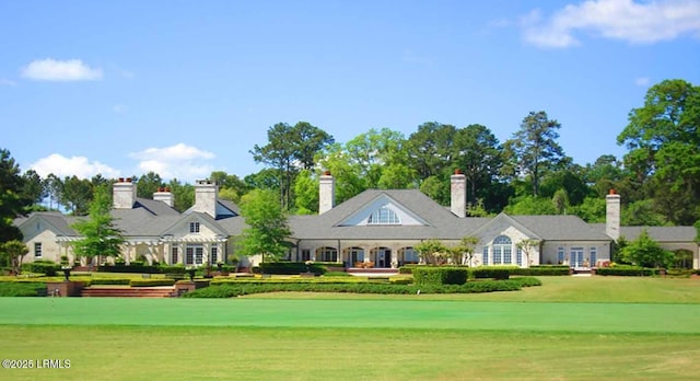 view of front facade with french doors and a front lawn