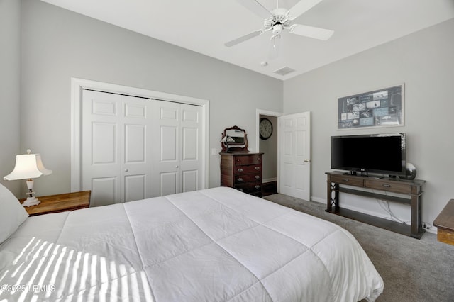 carpeted bedroom featuring ceiling fan and a closet