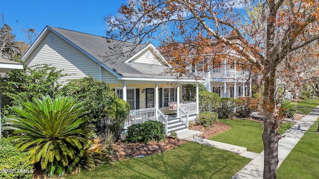 view of front of home featuring covered porch and a front yard