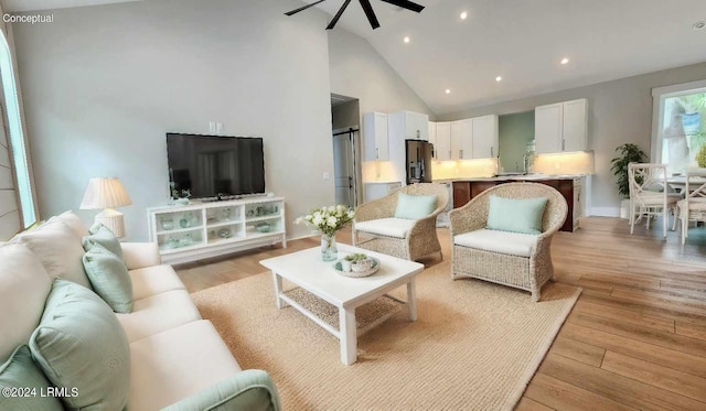 living room featuring sink, light hardwood / wood-style flooring, high vaulted ceiling, and ceiling fan