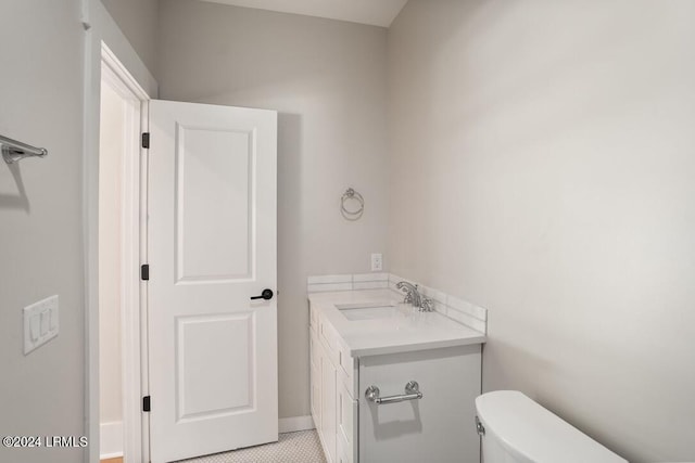 bathroom featuring vanity, tile patterned flooring, and toilet