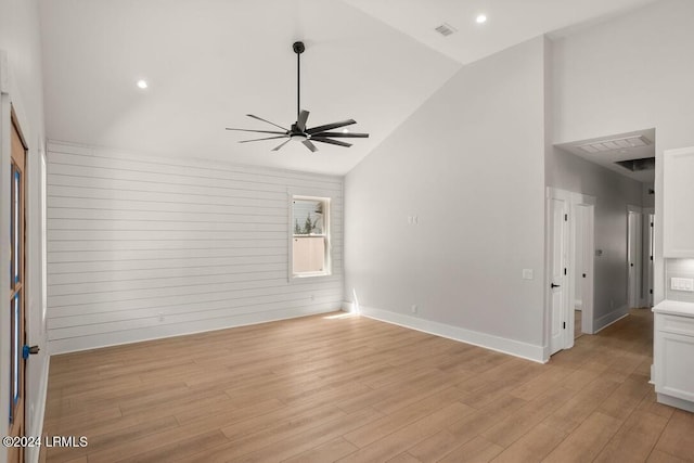 unfurnished room with lofted ceiling, ceiling fan, and light hardwood / wood-style flooring