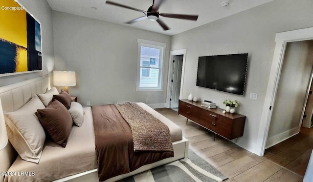 bedroom with light hardwood / wood-style floors and ceiling fan