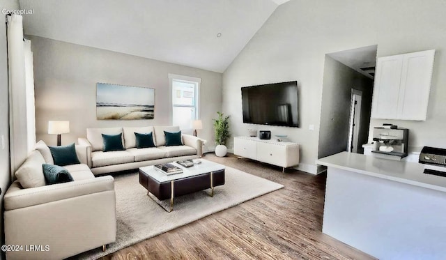 living room featuring lofted ceiling and dark hardwood / wood-style floors