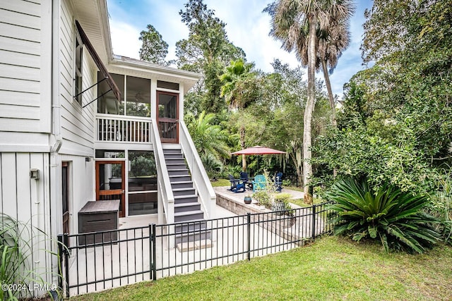 view of yard with a sunroom and a patio area