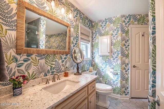 bathroom featuring vanity, tile patterned floors, and toilet