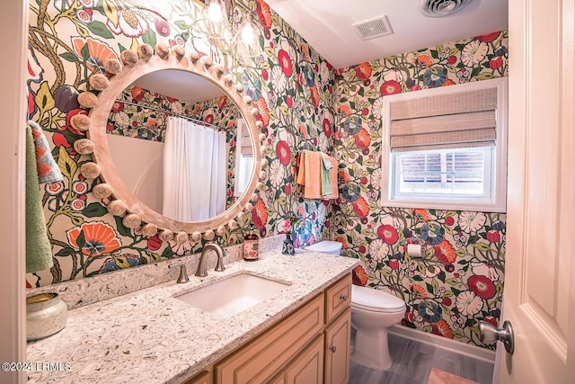 bathroom featuring vanity and toilet